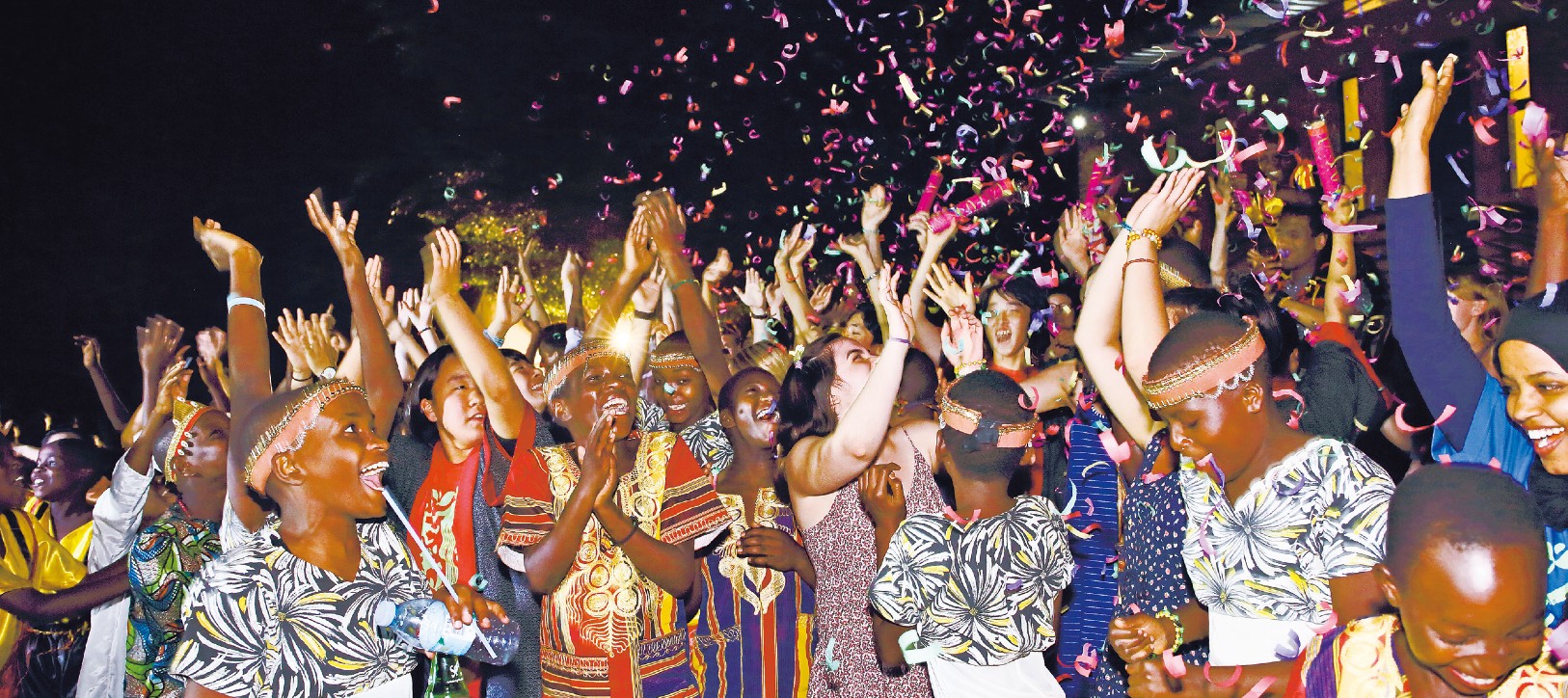 Children smiling and celebrating with confetti in the air